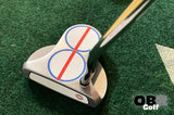 A golf putter with a red center line sticker on the head.