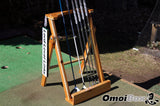 scotty cameron putter sitting on outdoor golf putter stand with personalized golf sign on perfect practice golf platform